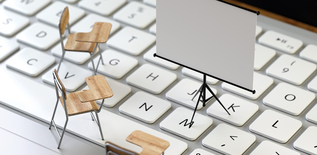 A keyboard with tiny wood chairs on it and a projector screen