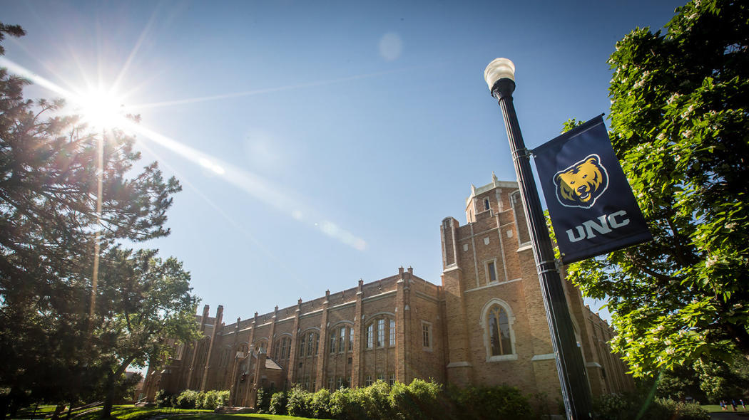 An image of Gunter Hall with a UNC Bears flag flying by it.
