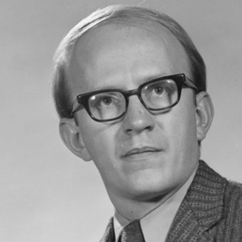 A black-and-white headshot of UNC alum and professor emeritus Bill Harmon.