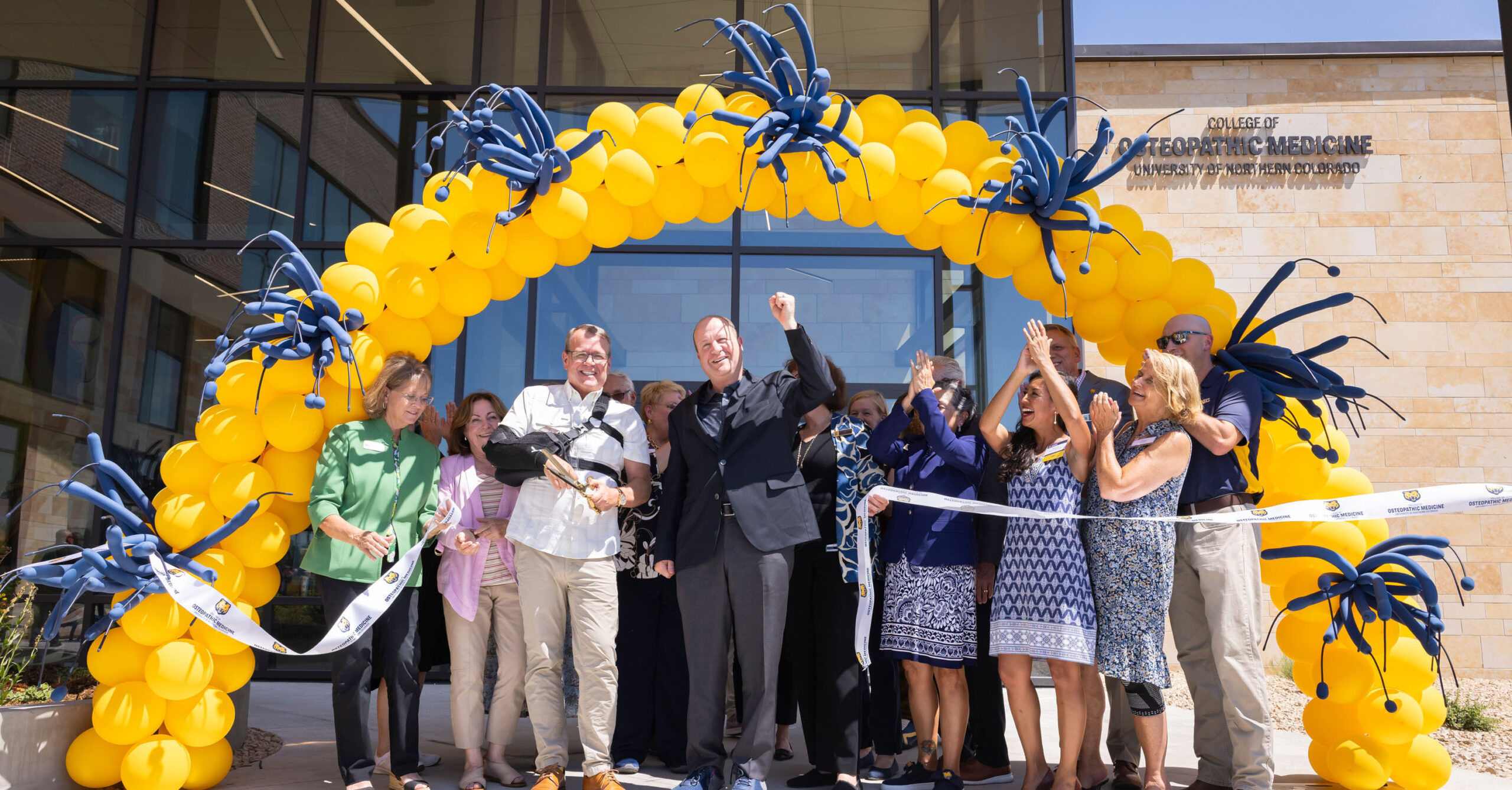 Celebration right after cutting the ribbon at the COM ribbon cutting ceremony