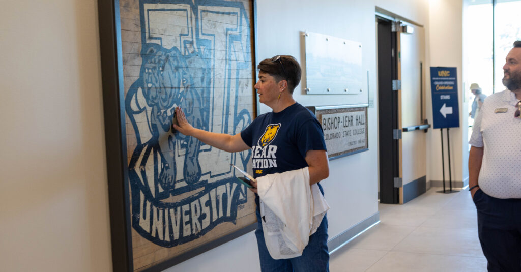 A person touching the Bishop Lehr Hall old center court