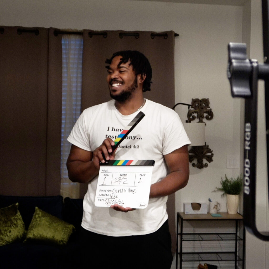 Carlito Hale holding up a clap board