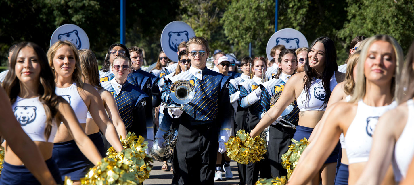 UNC Cheer introduces the UNC Pride of the Rockies Marching Band during Homecoming Parade