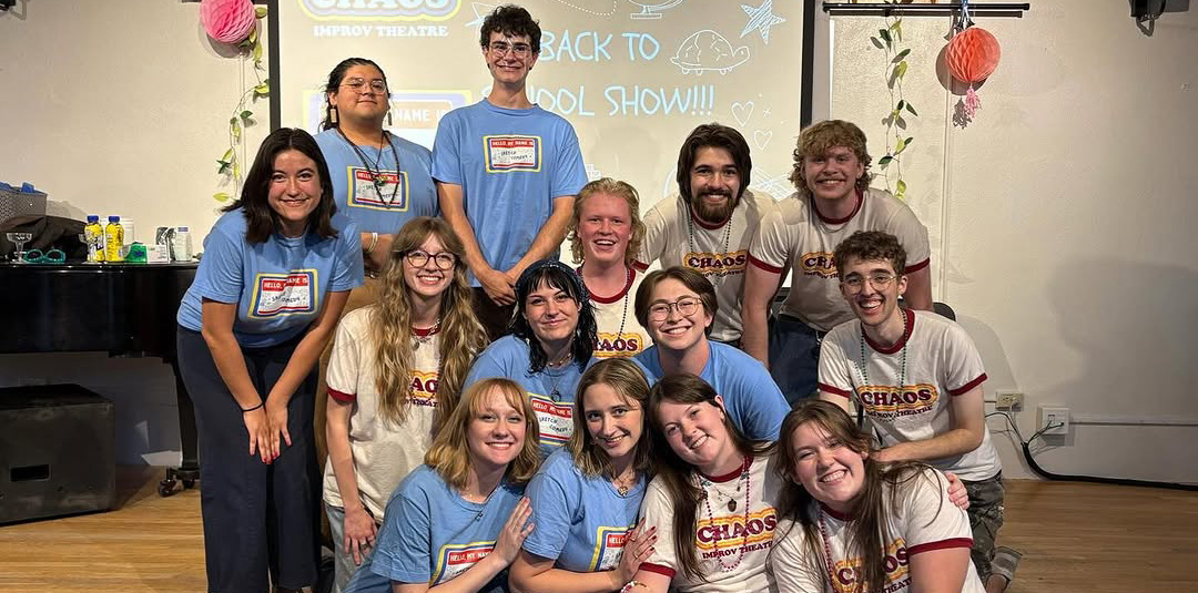 A group of students gathered together smiling at the camera