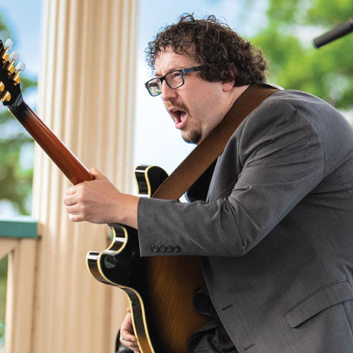 Connor Terrones playing the guitar and singing