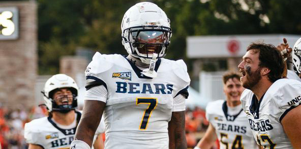 Darrell Bryant Jr. in his white UNC football uniform and helmet