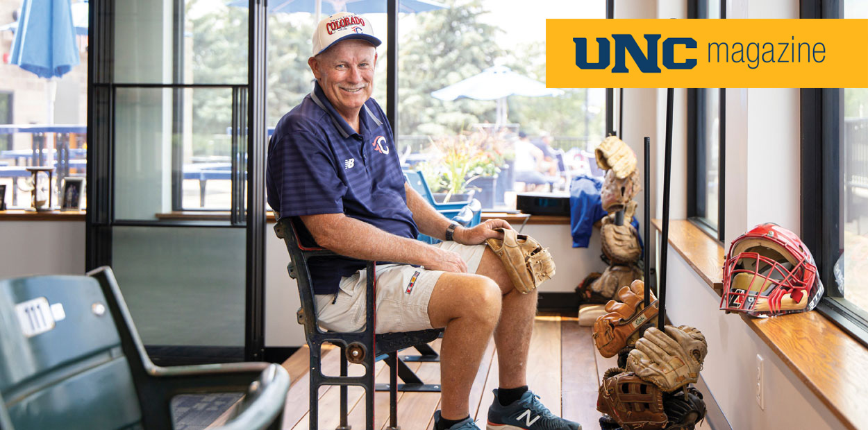 Dave King sitting in a chair surrounded by baseball gloves