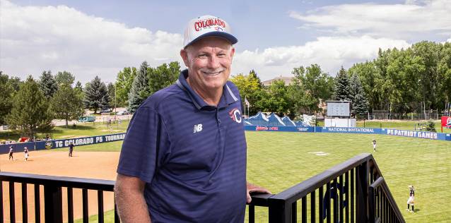 Dave King standing in front of a baseball field smiling