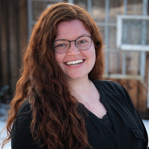 Estelle Staffieri wearing glasses smiling at the camera