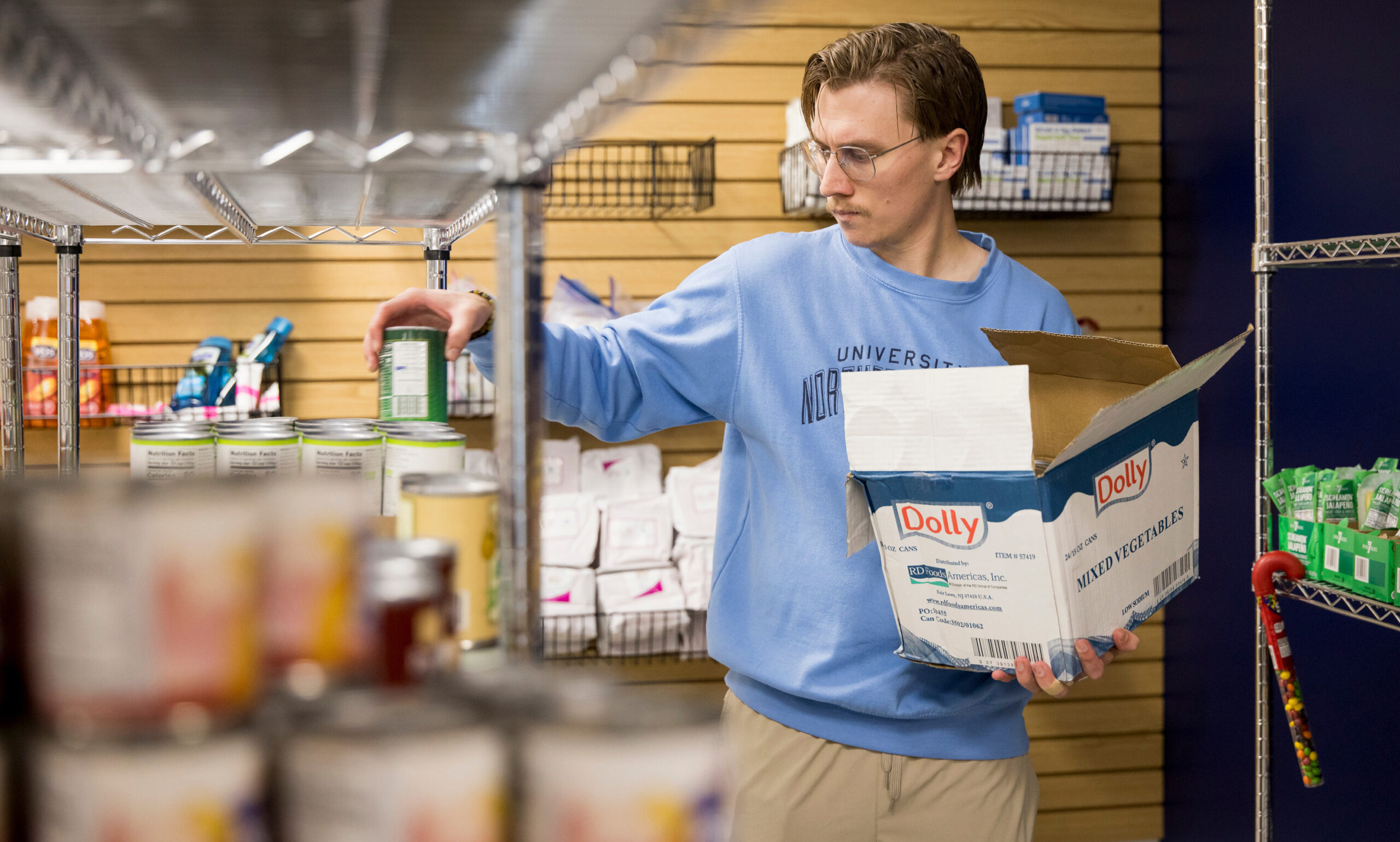 Freddie Horn putting canned food on a shelf