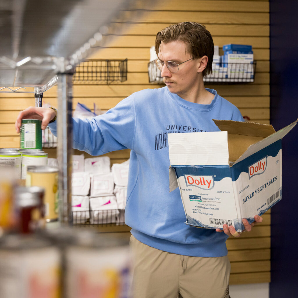 Freddie Horn stocking shelves in the Bear Pantry
