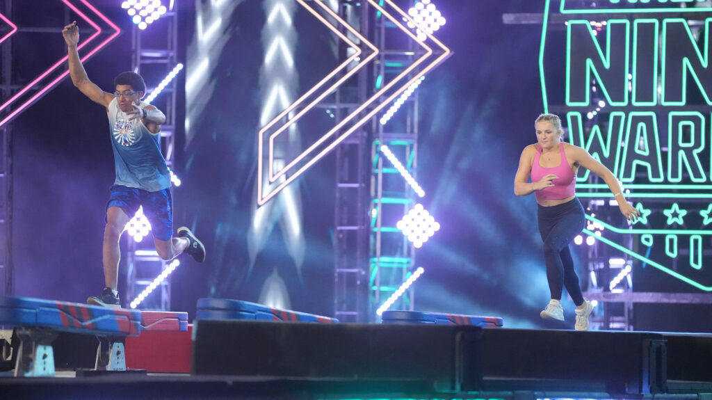 Taylor Greene competing against a male Ninja on American Ninja Warrior