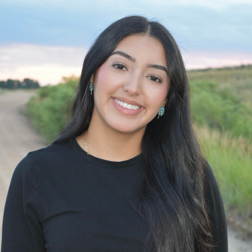 Haire Mercado Espinoza smiling while standing outside
