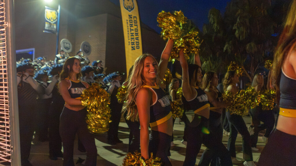UNC cheerleaders cheering at night