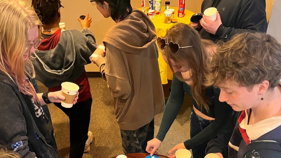 A group of students decorating hot chocolate cups