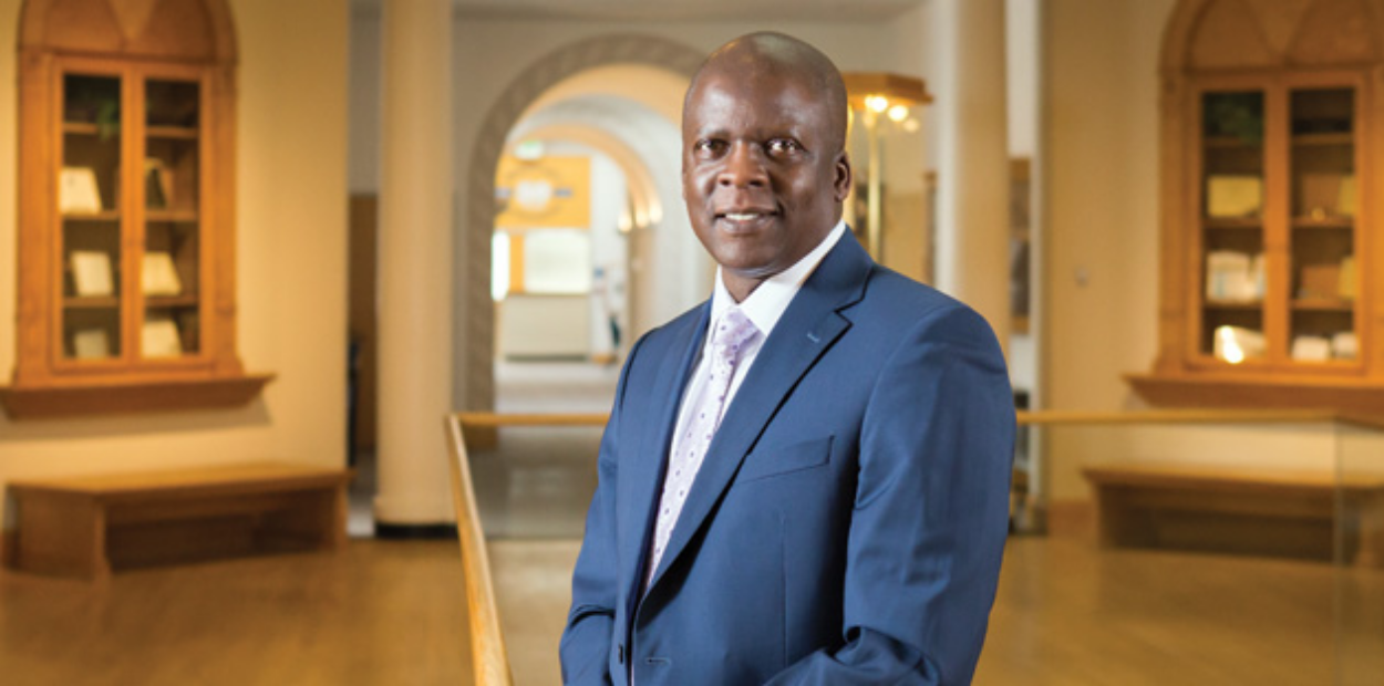 A formal photograph of UNC management professor Isaac Wanasika.
