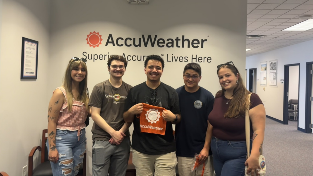 UNC student Janae Acheson standing with fellow AccuWeather interns in the office.