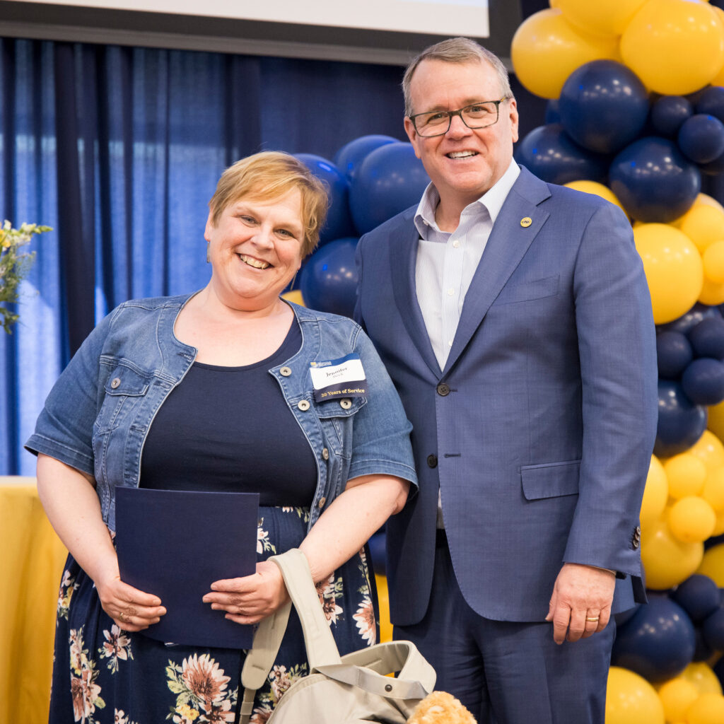 Jenn Beck on the left and Andy Feinstein on the right smiling for the camera