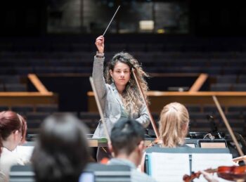 Colombian PhD student Jolie González Masmela conducting UNC Symphony Orchestra.