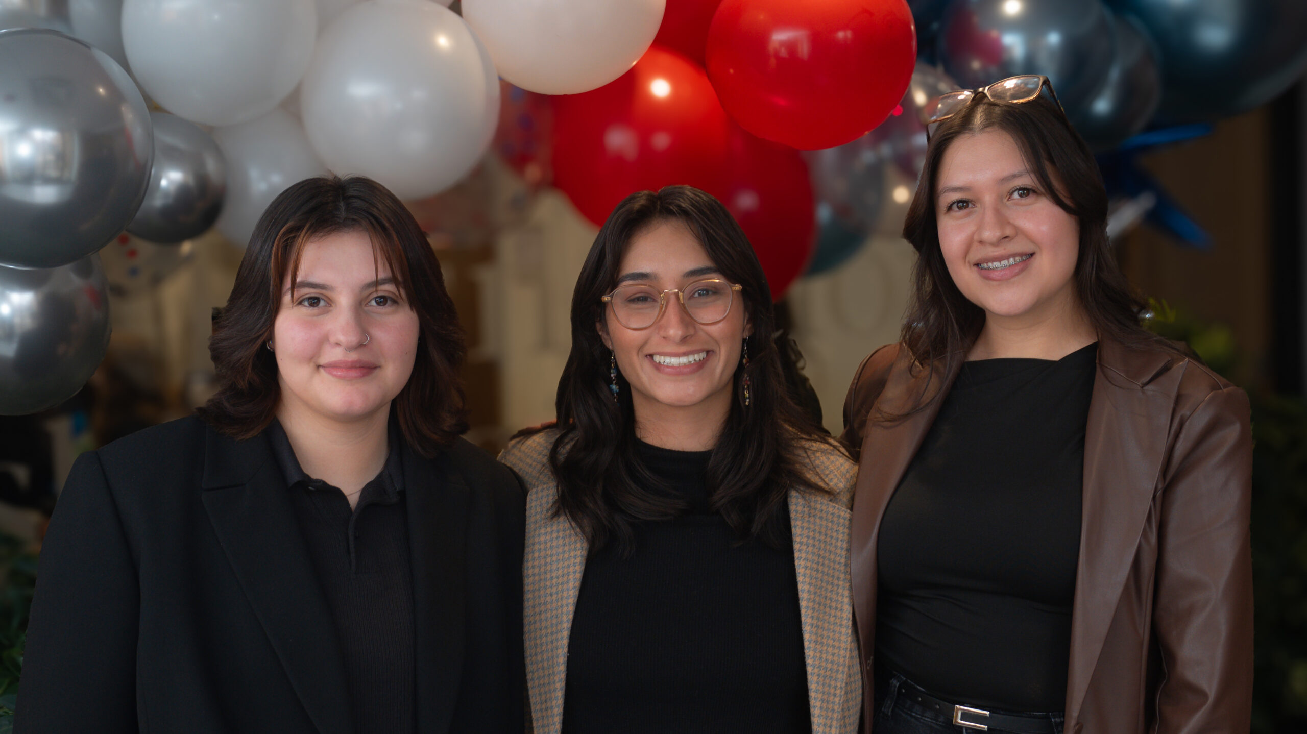 Kay Quintana on the left posing with two other group members