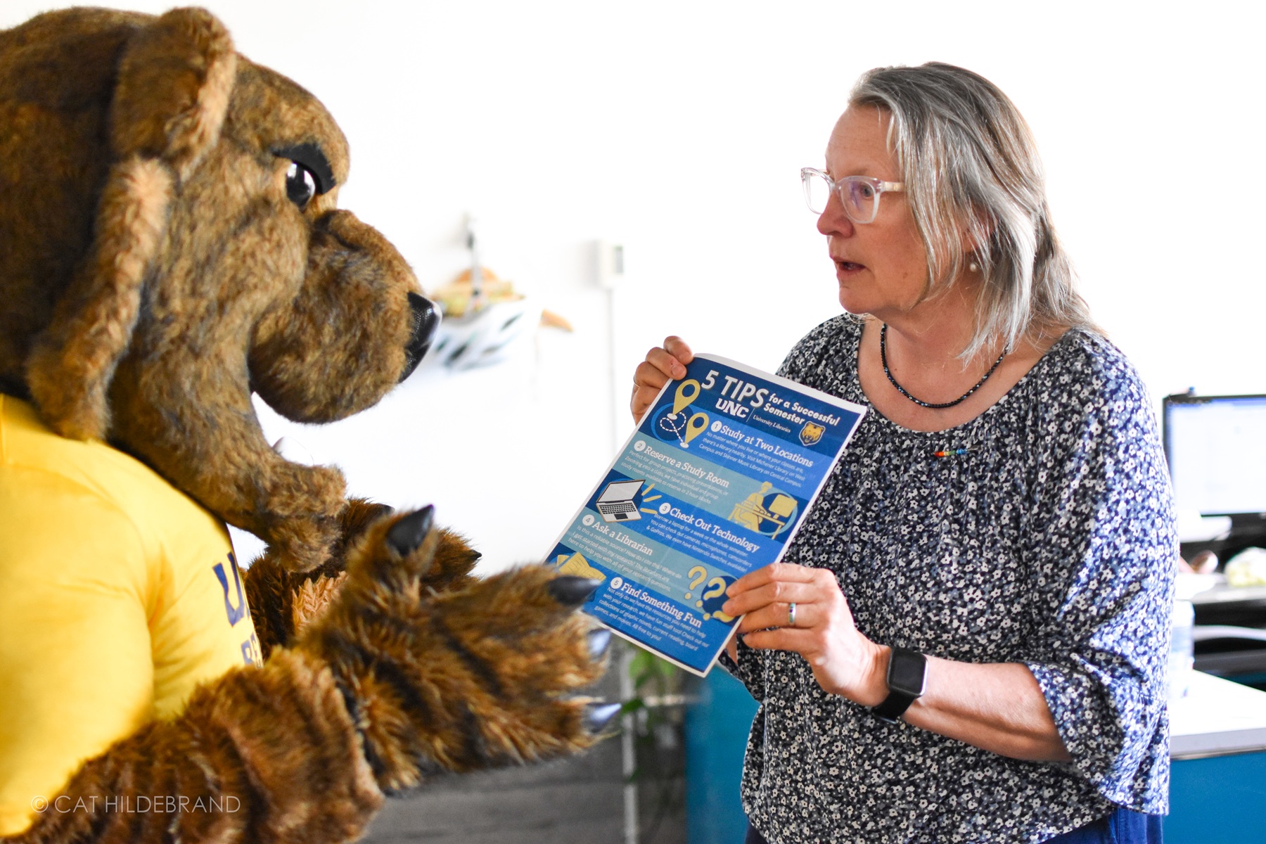 A librarian is showing a handout entitled 