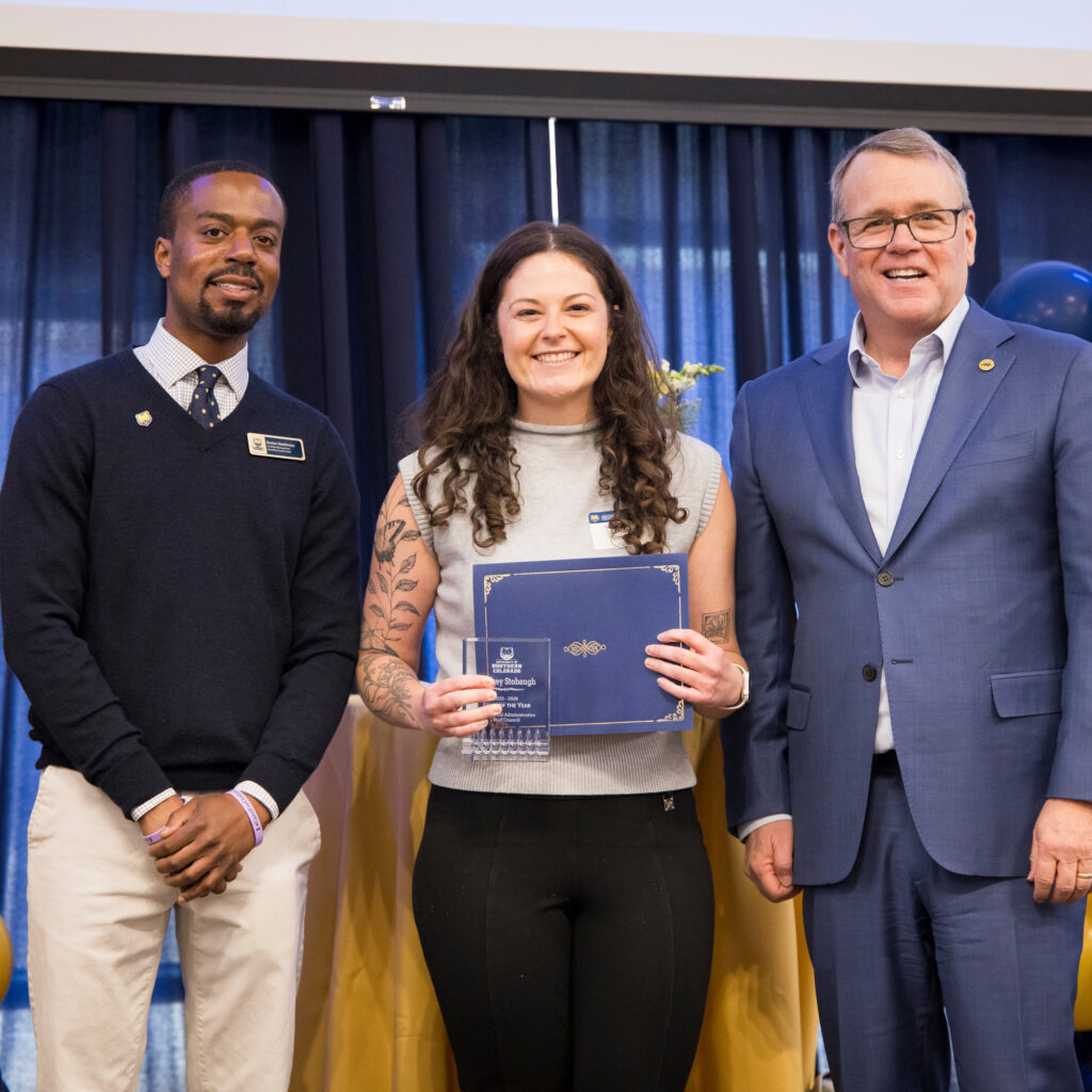 Lindsey Stobaugh standing between Andy Feinstein and David Henderson