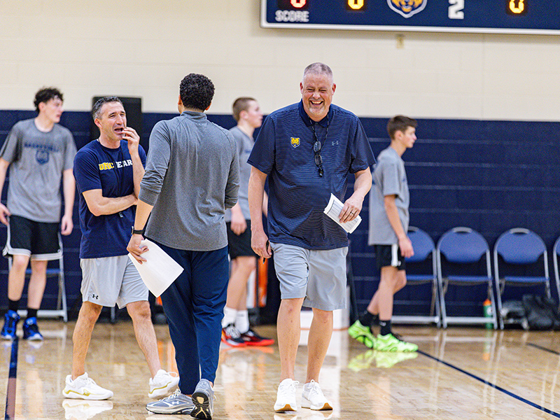 UNC kinesiology faculty members on a basketball court.