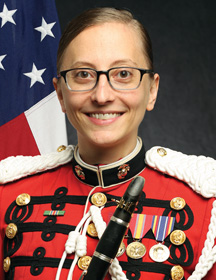 A headshot of UNC alum Lucia Disano wearing a formal marching band uniform.