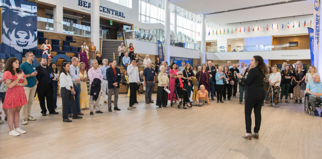 A woman speaking to a crowd in the Campus Commons