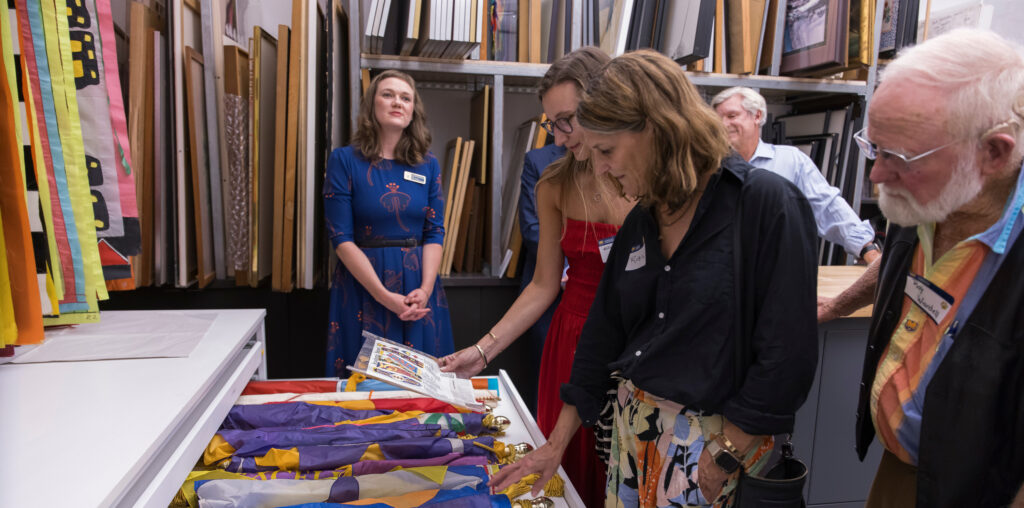 People looking at Lydia Ruyle's art