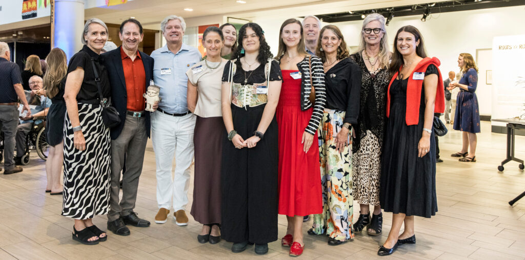 A group of people smiling and looking at the camera