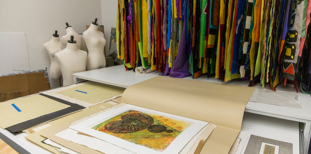 A stack of Lydia Ruyle's artwork