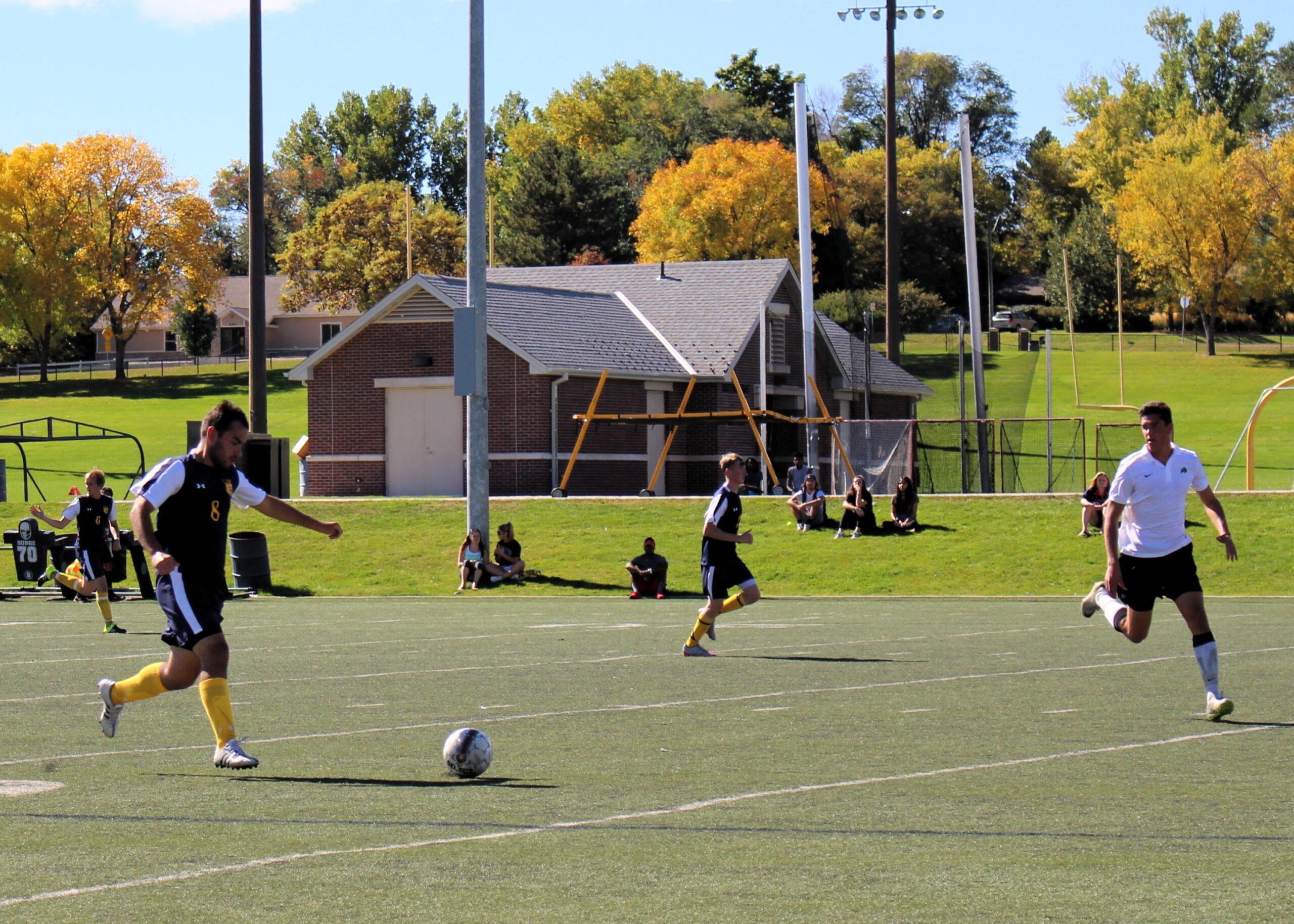 Photo of Men's Soccer Club match with two opposing players on the field