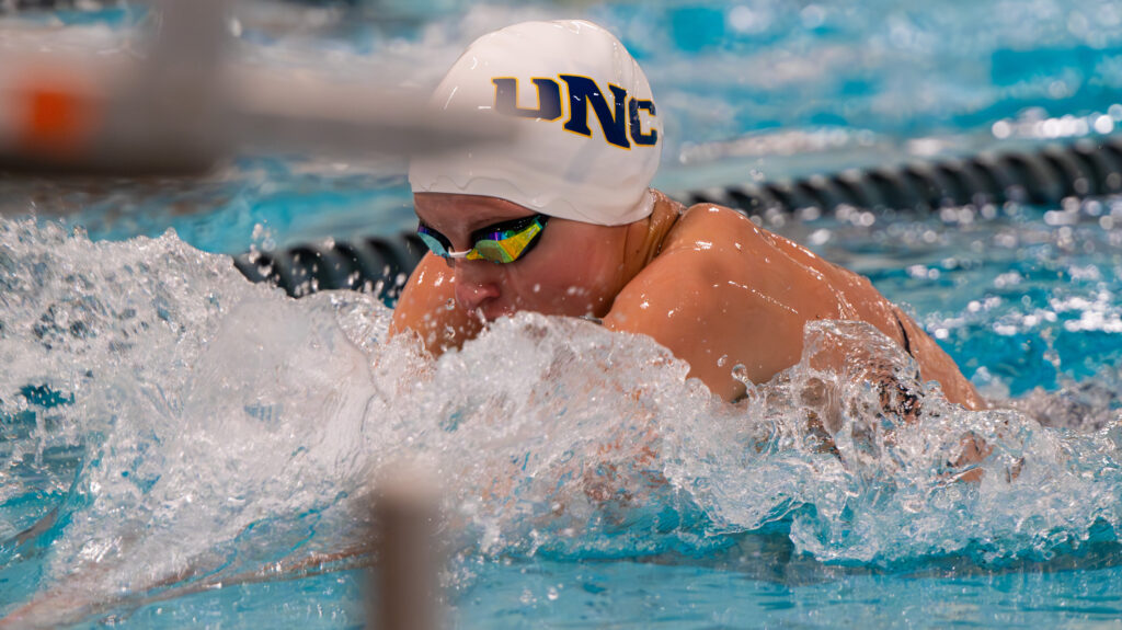 Maria Erokhina swimming wearing a UNC swim cap