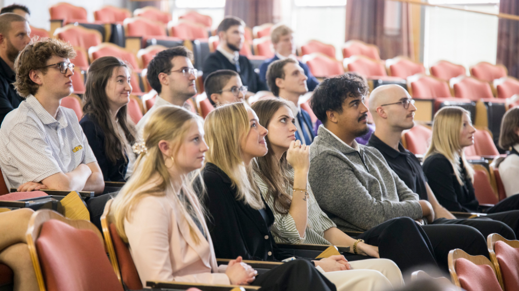 A group of students seated in an auditorium.
