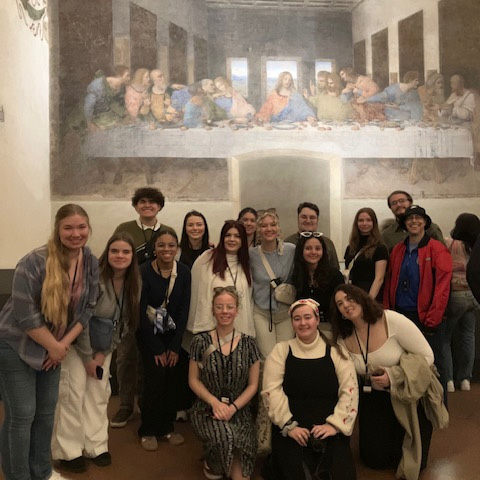 A group of UNC students standing in front of The Last Supper painting