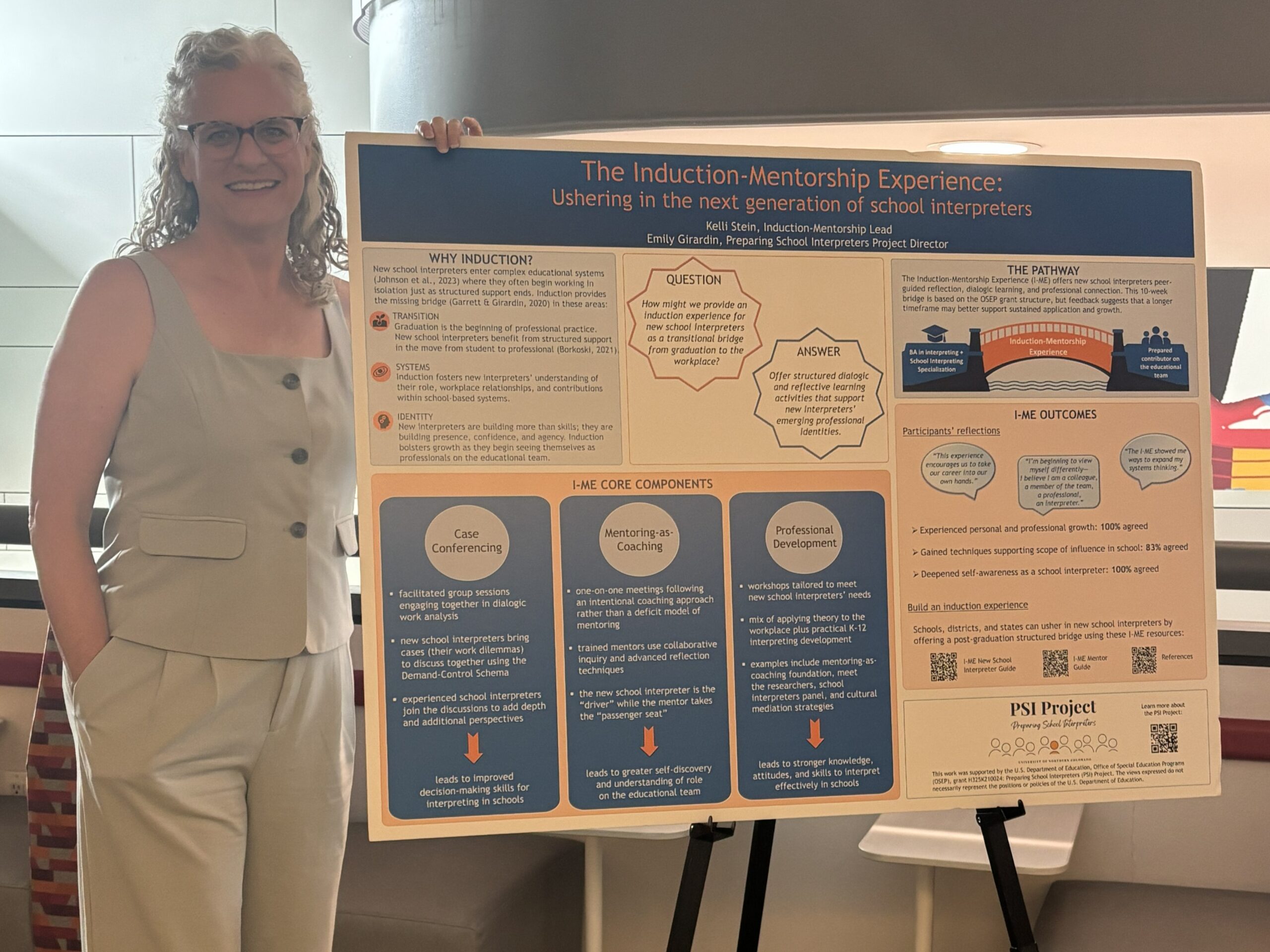 Kelli Stein standing beside The Induction-Mentorship Experience poster at the 2026 NAIE Conference.