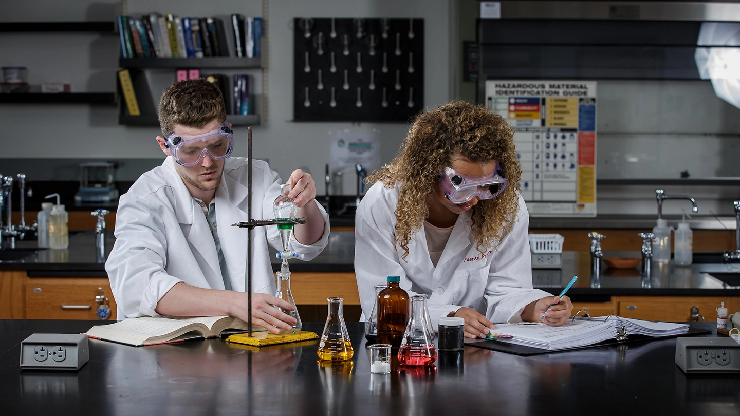 Two NHS student working in chemistry lab.