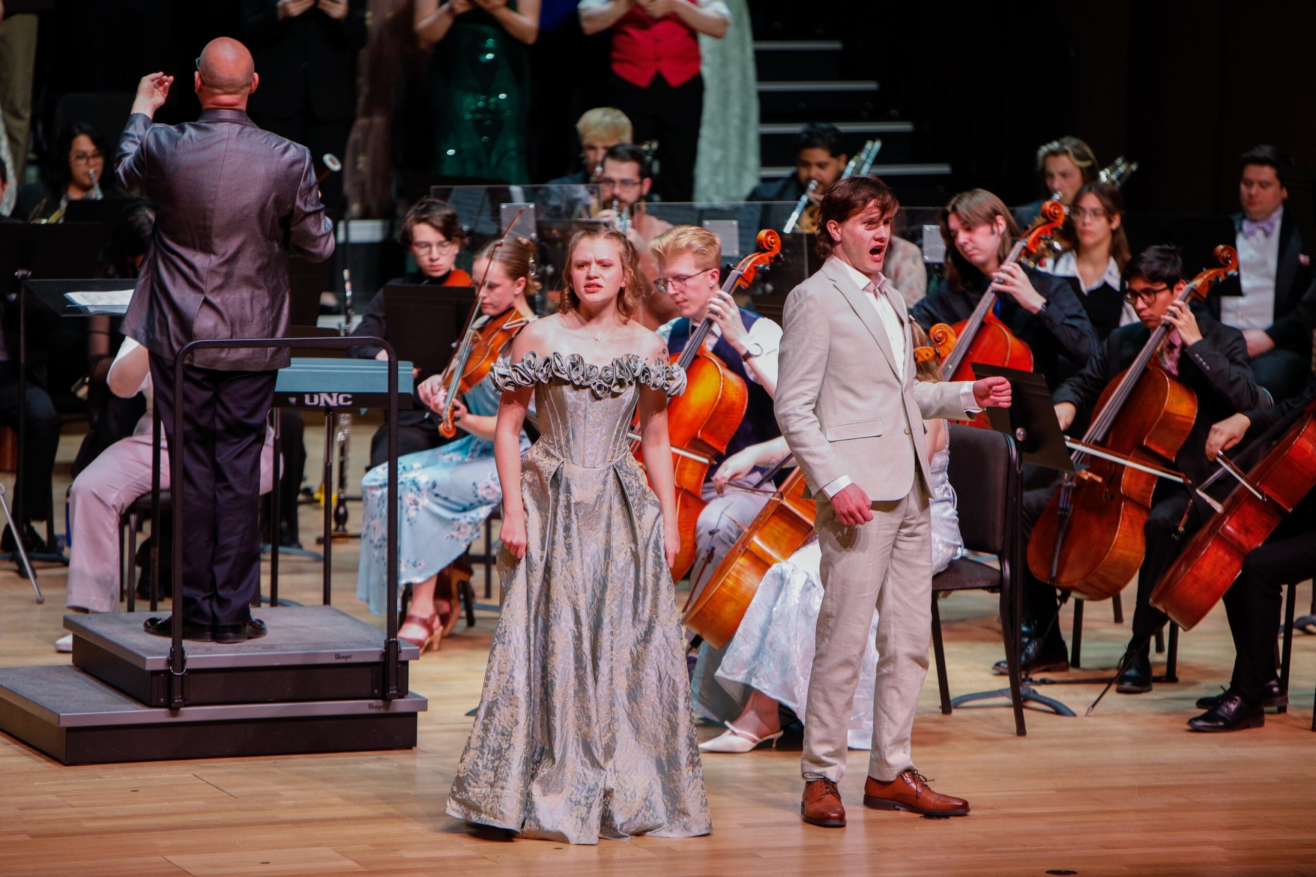 Two soloists singing in front of the orchestra at Opera in Bloom 2026.