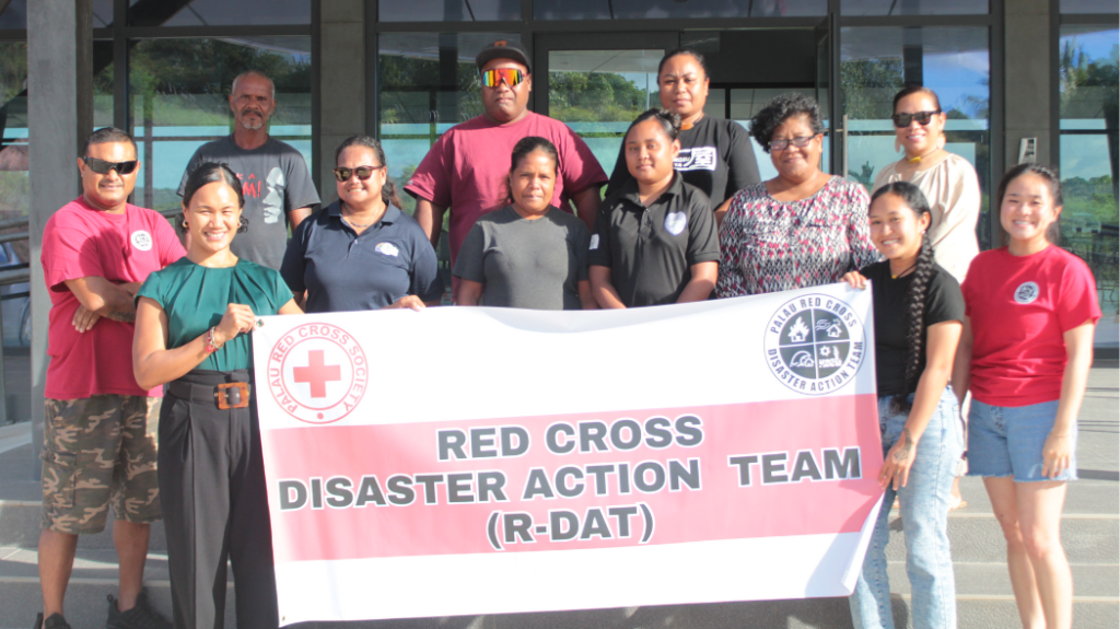 UNC student Peyton Eitemiller posing with other Red Cross workers in front of a building in Palau.