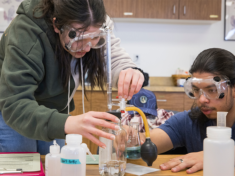 Two students at the Poudre Learning Center doing a science experiment.