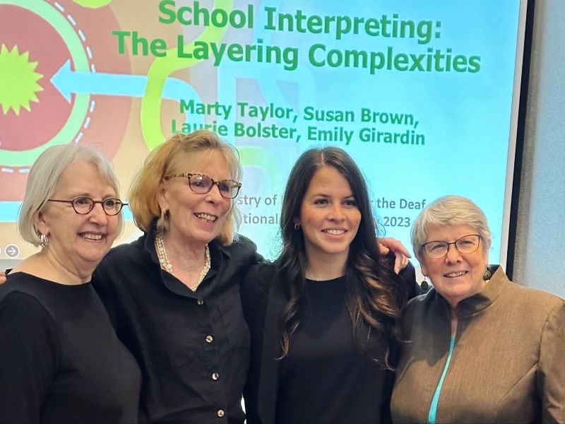 Marty Taylor, Susan Brown, Laurie Bolster, and Dr. Emily Girardin stand together following their presentation, “School Interpreting: The Layering Complexities,” at the 2023 Registry of Interpreters for the Deaf Conference.