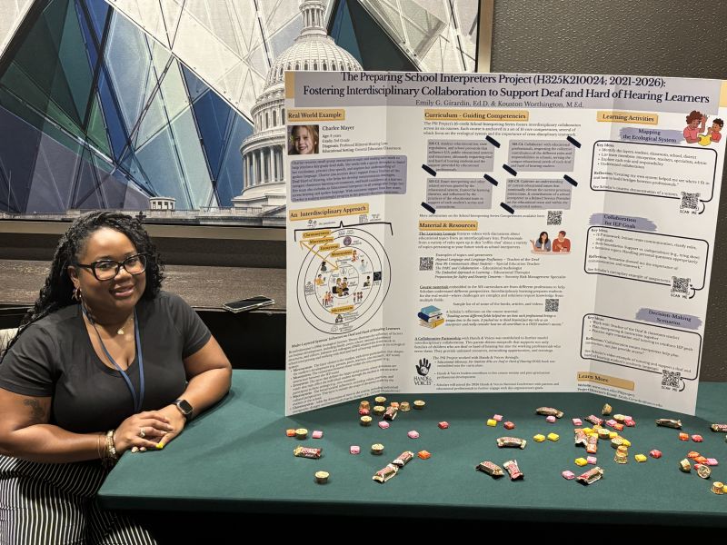 Kouston Worthington sits beside the PSI Project poster “Fostering Interdisciplinary Collaboration to Support Deaf and Hard of Hearing Learners” at the 2025 Registry of Interpreters for the Deaf Conference.