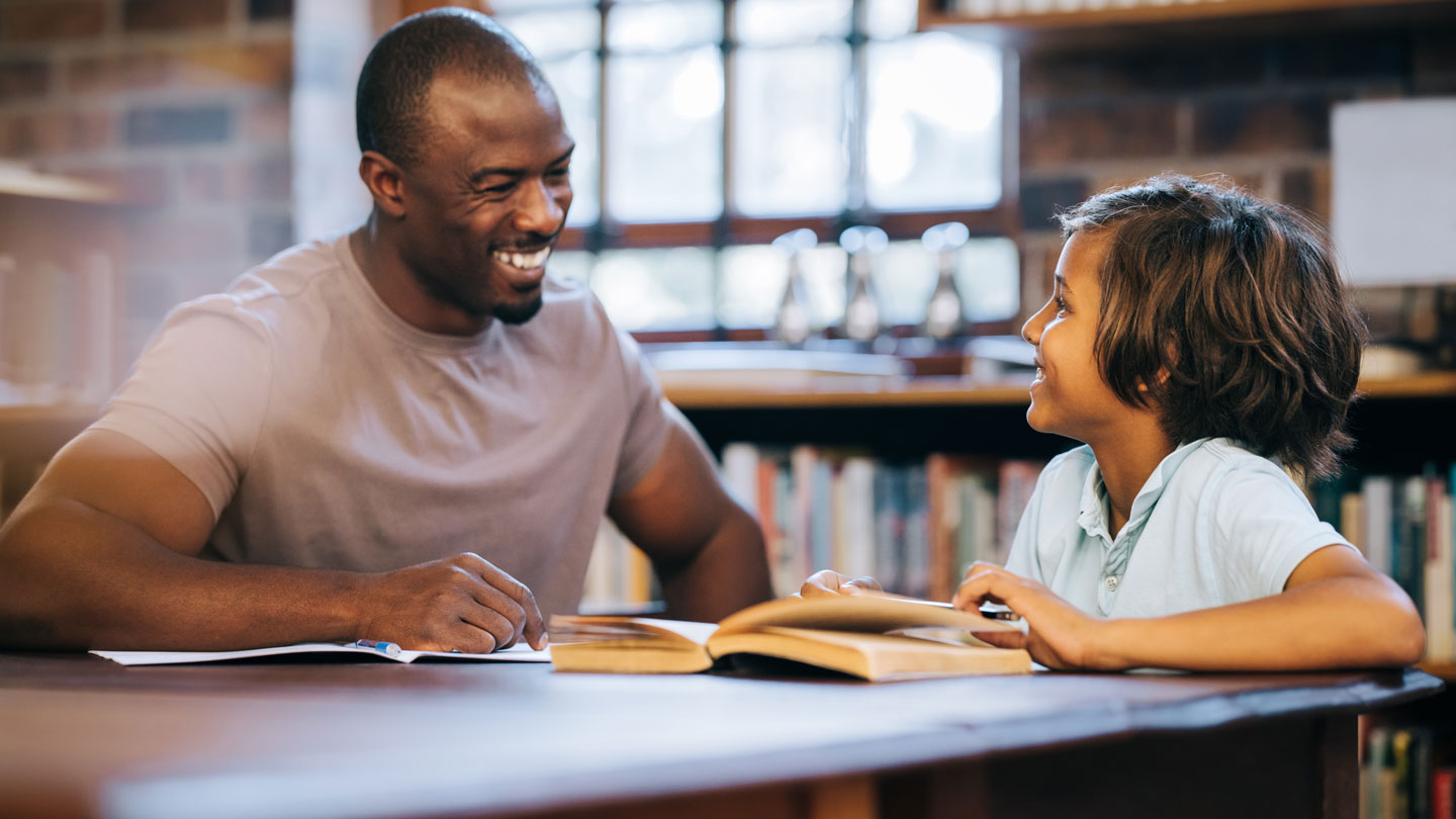 School counselor talking to a young student.