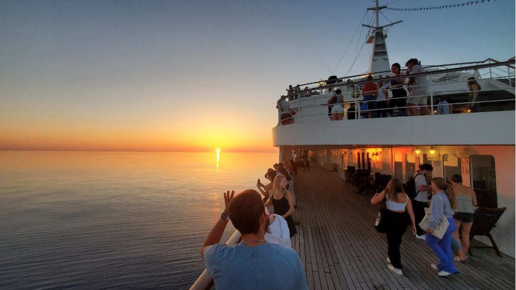 An image of a sunset taken from the deck of a cruise ship.