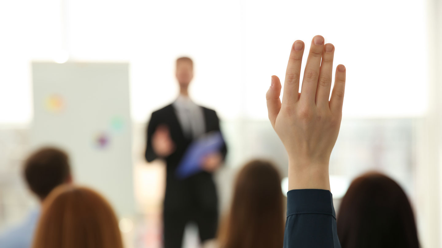 Student's hand raised in class.