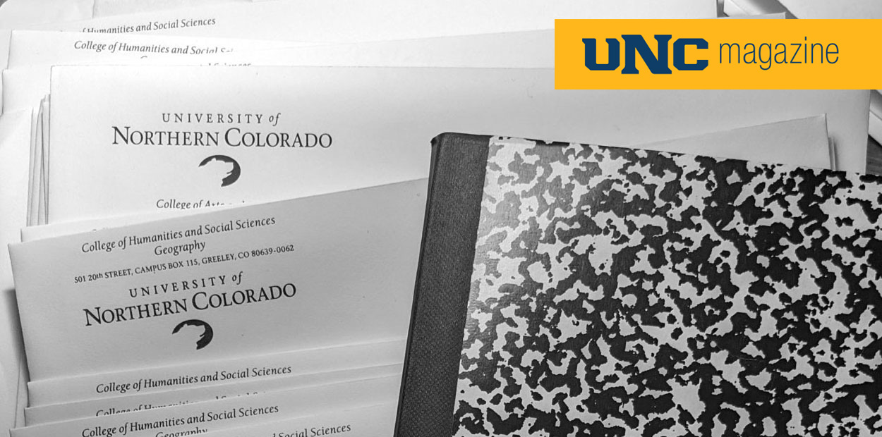 UNC letters stacked in a pile next to a composition notebook