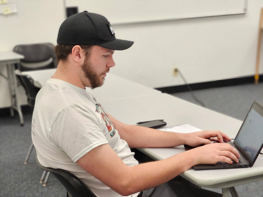 Student typing on a laptop
