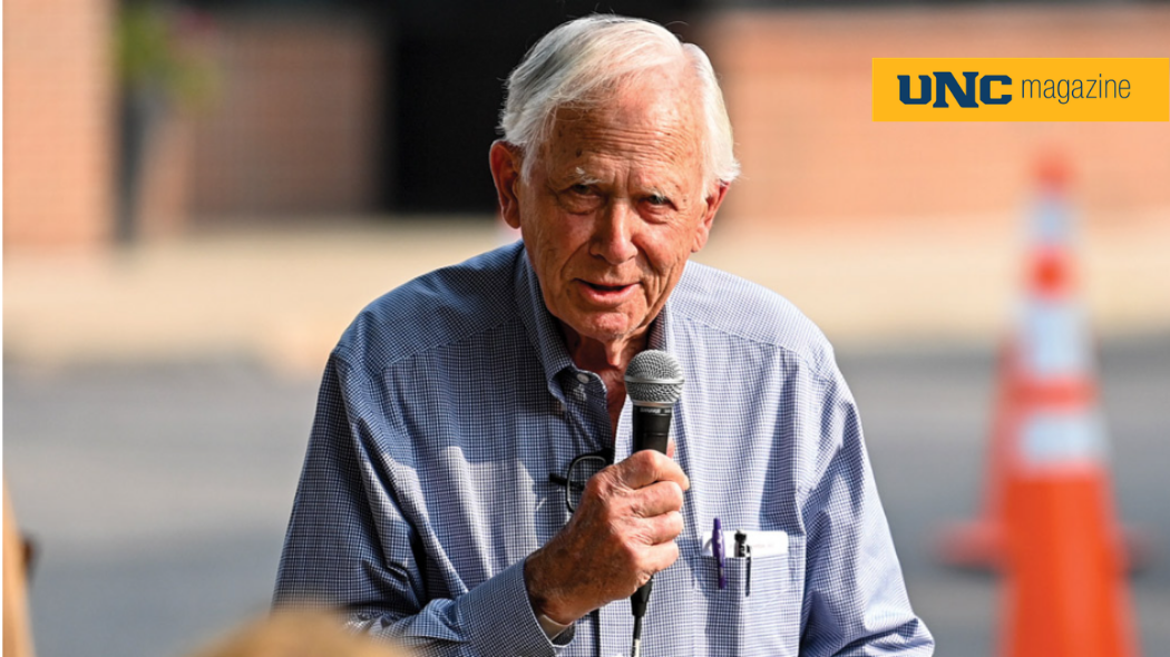 A photo of Bob Tointon speaking into a microphone outside.