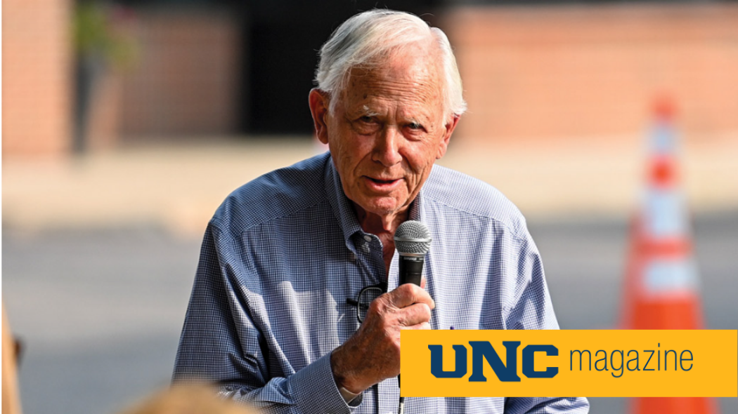 UNC alum Bob Tointon speaking into a mircophone.